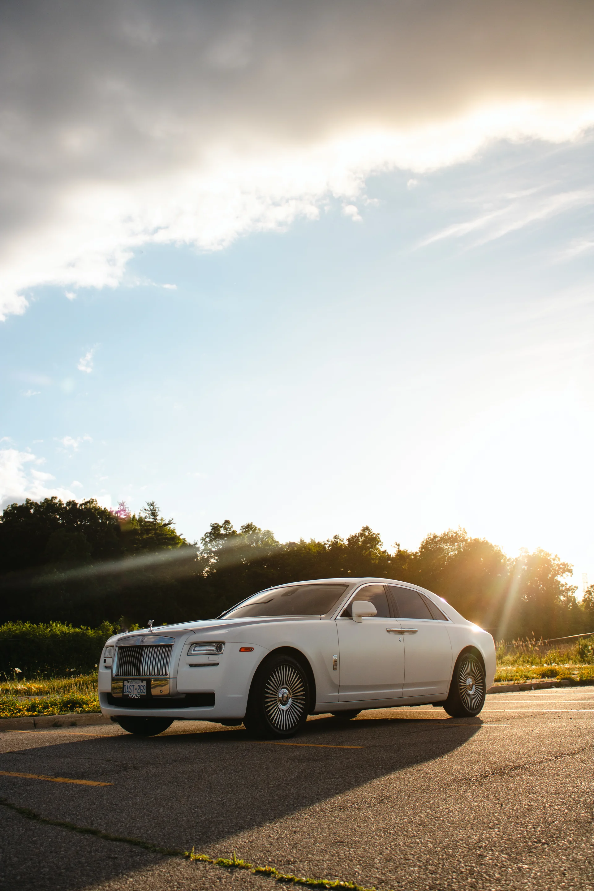 A Rolls-Royce with the low sun flaring straight across the lens at the Vitesse v1 meet.